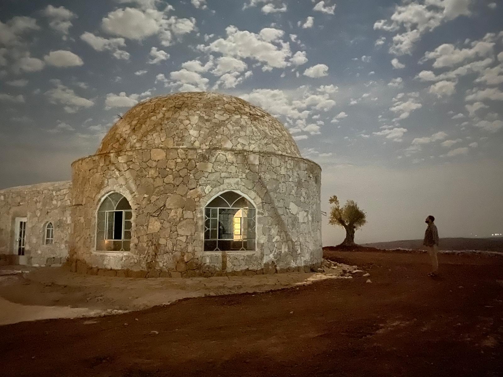 The prayer house under a moonlit sky