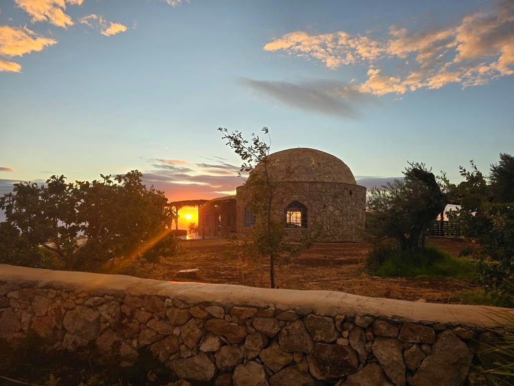 Sunset through the prayer house at Arugot